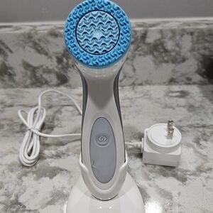 Nuskin Lumispa white and blue facial brush with the charging base